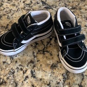 Black and white high top vans